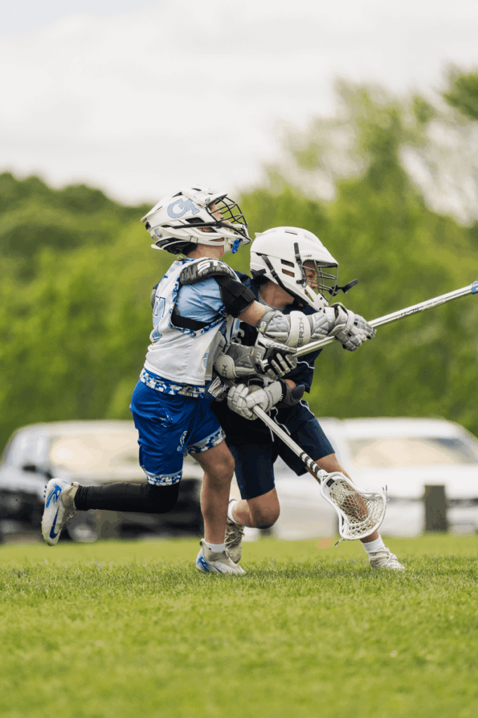 Two young lacrosse players in action during a game